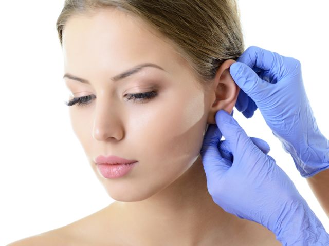 Young woman face with beauty treatment ear plastic isolated